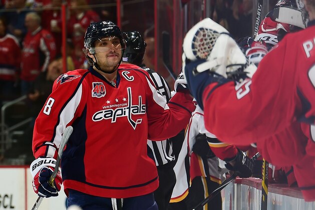 WASHINGTON, DC - NOVEMBER 04:  Alex Ovechkin #8 of the Washington Capitals celebrates with his teammates after assisting on a goal by Nicklas Backstrom #19 in the first period against the Calgary Flames during an NHL game at Verizon Center on November 4, 2014 in Washington, DC. Ovechkin became the Capitals franchise points leader with his 826th career point passing Peter Bondra.  (Photo by Patrick McDermott/NHLI via Getty Images)