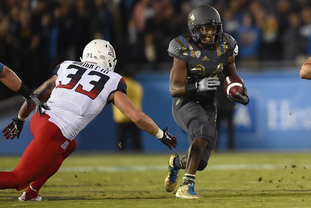 Arizona linebacker Scooby Wright III (33) attempts the tackle of UCLA running back Paul Perkins (24) during the first half of an NCAA college football game, Saturday, Nov. 1, 2014, in Pasadena, Calif. (AP Photo/Gus Ruelas)