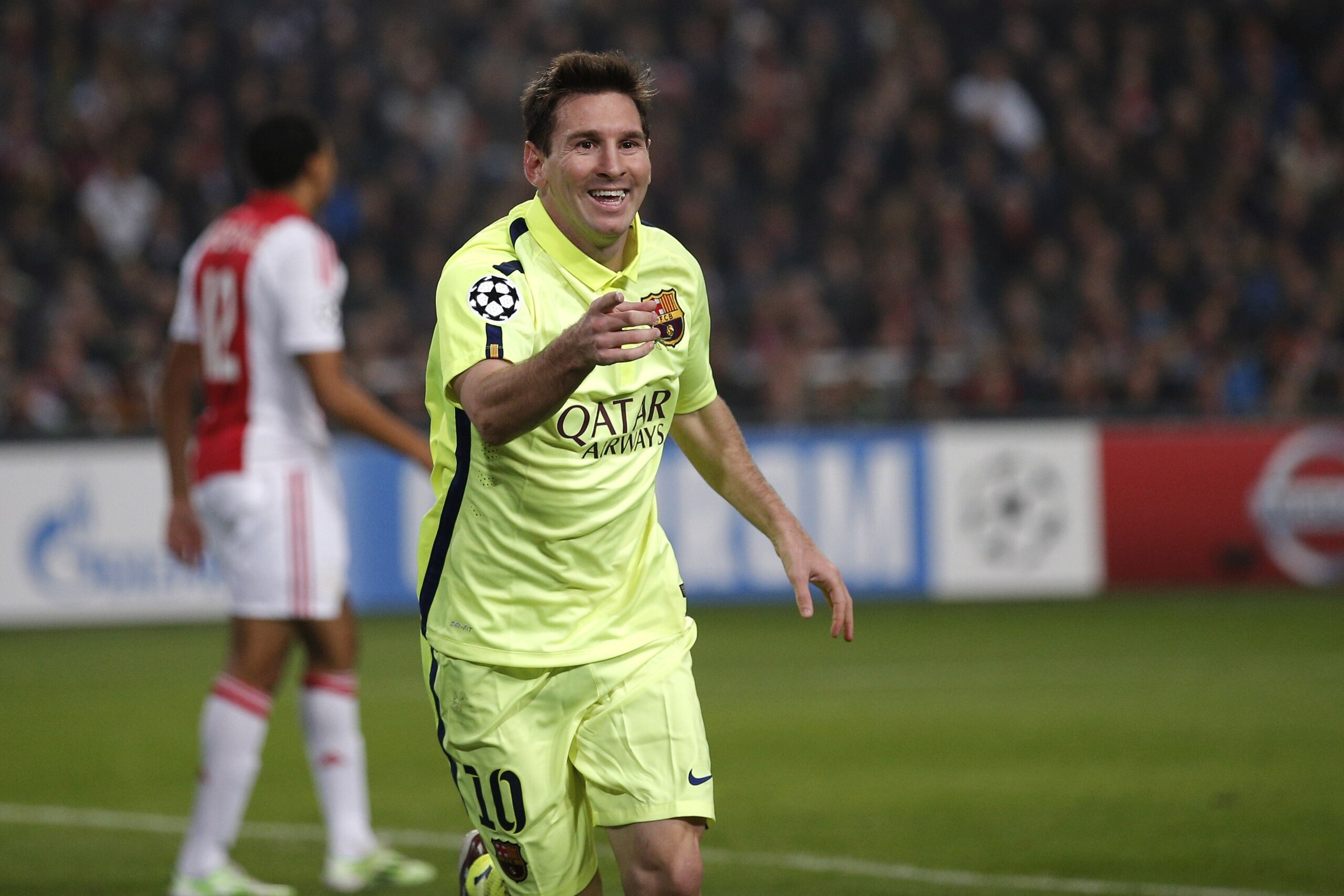 Barcelona's Lionel Messi celebrates scoring his side's 2nd goal during the Group F Champions League match between AFC Ajax and FC Barcelona at ArenA stadium in Amsterdam, Netherlands, Wednesday, Nov. 5, 2014. (AP Photo/Peter Dejong)