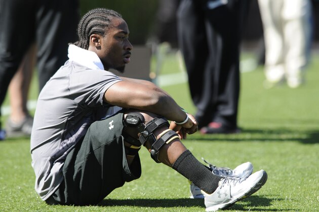 Running back Marcus Lattimore looks out on the field before the start of the South Carolina's NFL Pro Day Wednesday, March 27, 2013 in Columbia, S.C.(AP Photo/Mary Ann Chastain)