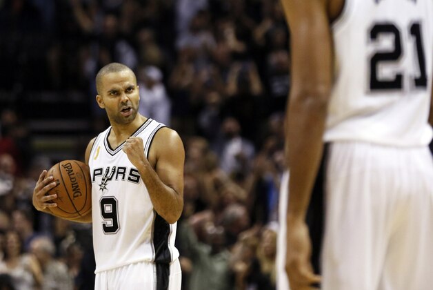 Oct 28, 2014; San Antonio, TX, USA; San Antonio Spurs point guard Tony Parker (9) celebrates the win with San Antonio Spurs power forward Tim Duncan (21) against the Dallas Mavericks during the second half at AT&T Center. The Spurs won 101-100. Mandatory Credit: Soobum Im-USA TODAY Sports