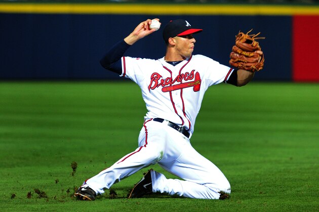 ATLANTA, GA - JUNE 17: Andrelton Simmons #19 of the Atlanta Braves attempts to throw out a runner at first base during the ninth inning against the Philadelphia Phillies at Turner Field on June 17, 2014 in Atlanta, Georgia. (Photo by Scott Cunningham/Getty Images)
