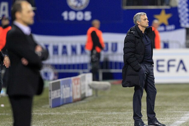 Chelsea's head coach Jose Mourinho, right, watches a game in front of Maribor's head coach Ante Simundza during the Champions League group G soccer match between Chelsea FC and Maribor, in Maribor, Slovenia, Wednesday, Nov. 5, 2014. (AP Photo/Nikola Solic)