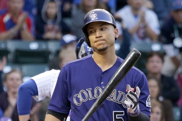 Colorado Rockies' Carlos Gonzalez flips his bat after striking out on a pitch from Chicago Cubs' Tsuyoshi Wada during the first inning of a baseball game Monday, July 28, 2014, in Chicago. (AP Photo/Charles Rex Arbogast)