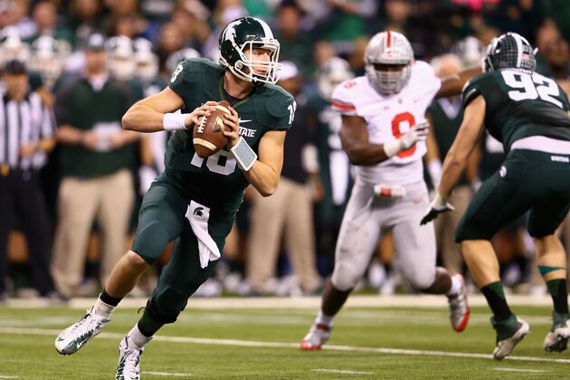INDIANAPOLIS, IN - DECEMBER 07:  Quarterback Connor Cook #18 of the Michigan State Spartans looks to pass against the defense of the Ohio State Buckeyes during the Big Ten Conference Championship game at Lucas Oil Stadium on December 7, 2013 in Indianapolis, Indiana.  (Photo by Andy Lyons/Getty Images)