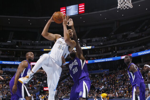 Denver Nuggets center JaVale McGee, second from left, goes up for shot as, from left, Sacramento Kings forwards Carl Landry and Reggie Evans cover in the third quarter of the Kings' 110-105 victory in an NBA basketball game in Denver on Monday, Nov. 3, 2014. Looking on are Kings guard Darren Collison, fourth from left, and Nuggets guard Ty Lawson. (AP Photo/David Zalubowski)