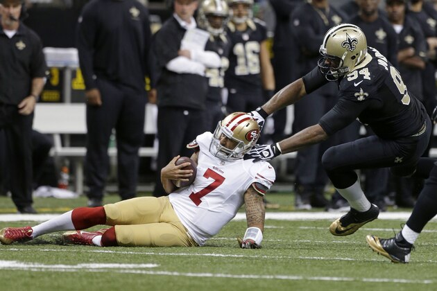 San Francisco 49ers quarterback Colin Kaepernick (7) slides as he is stopped by New Orleans Saints defensive end Cameron Jordan (94) in the first half of an NFL football game in New Orleans, Sunday, Nov. 17, 2013. (AP Photo/Dave Martin)
