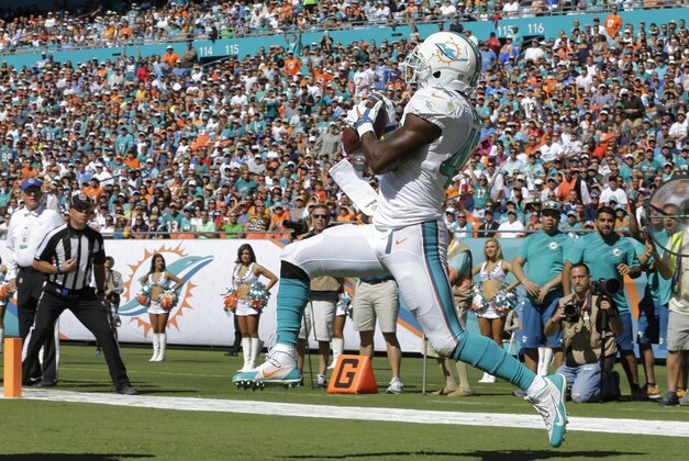 Miami Dolphins tight end Charles Clay (42) catches a touchdown pass during the first half of an NFL football game against the San Diego Chargers, Sunday, Nov. 2, 2014, in Miami Gardens, Fla.  (AP Photo/Alan Diaz)