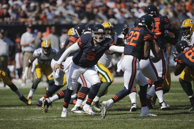 Chicago Bears quarterback Jay Cutler (6) hands off to running back Matt Forte (22) in the first half of an NFL football game against the Green Bay Packers Sunday, Sept. 28, 2014, in Chicago. (AP Photo/Charles Rex Arbogast)
