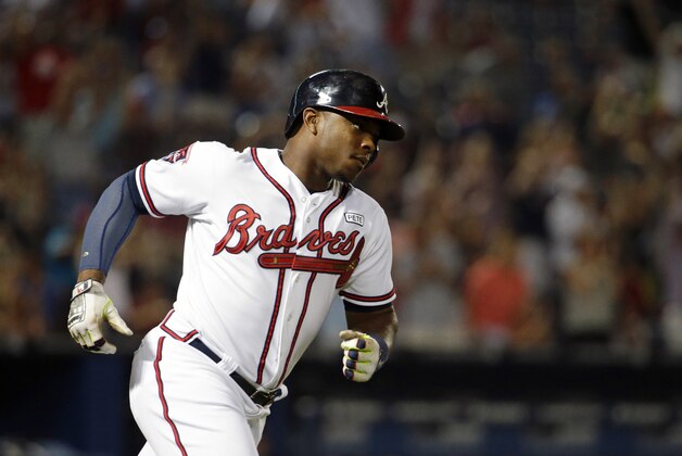Atlanta Braves' Justin Upton rounds the bases after hitting a two-run home run to score teammate Freddie Freeman in the sixth inning of a baseball game against the Miami Marlins, Friday, Aug. 29, 2014, in Atlanta. (AP Photo/David Goldman)