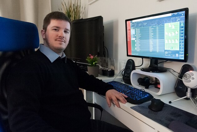Daniel Jonsson pictured at home playing Football Manager.