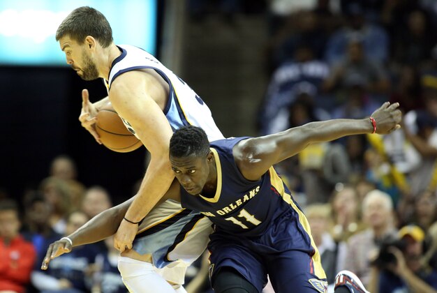 Nov 3, 2014; Memphis, TN, USA; Memphis Grizzlies center Marc Gasol (33) protects the ball as New Orleans Pelicans guard Jrue Holiday (11) attempts a steal during the second half at FedExForum. Memphis defeated New Orleans 93-81. Mandatory Credit: Nelson Chenault-USA TODAY Sports
