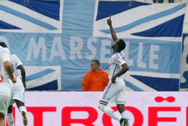 Marseille's Cameroonian defender Nicolas NKoulou, celebrates  after scoring against Toulouse, during their League One soccer match, at the Velodrome Stadium, in Marseille, southern France, Sunday, Oct. 19, 2014. (AP Photo/Claude Paris)
