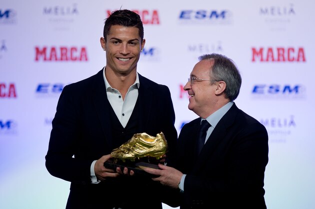 MADRID, SPAIN - NOVEMBER 05:  Cristiano Ronaldo (L) of Real Madrid CF receives the Golden Boot award from president of Real Madrid CF Florentino Perez (R) at Melia Castilla hotel on November 5, 2014 in Madrid, Spain. Cristiano Ronaldo's 31 strikes in La Liga last season have given him his third Golden Boot award. This year he has shared the award with FC Barcelona player Luis Suarez for the best scorer in Europe. Both players have scored the same number of goals thorough 2013-2014 season.  (Photo by Gonzalo Arroyo Moreno/Getty Images)