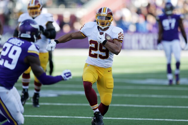 Washington Redskins running back Roy Helu, right, runs from Minnesota Vikings cornerback Xavier Rhodes, left, during the first half of an NFL football game, Sunday, Nov. 2, 2014, in Minneapolis. (AP Photo/Jim Mone)