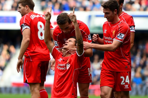 LONDON, ENGLAND - OCTOBER 19:  Philippe Coutinho of Liverpool celebrates with team-mates after scoring his team's second goal during the Barclays Premier League match between Queens Park Rangers and Liverpool at Loftus Road on October 19, 2014 in London, England.  (Photo by Paul Gilham/Getty Images)