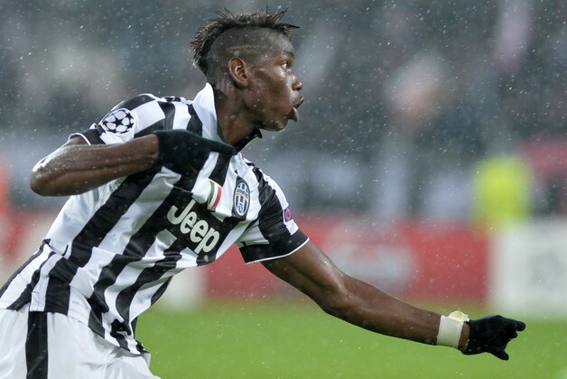 Juventus' Paul Pogba celebrates after scoring the third goal of his team during a Champions League, Group A soccer match between Juventus and Olympiakos, at the Juventus Stadium in Turin, Italy, Tuesday, Nov. 4, 2014. (AP Photo/Massimo Pinca)