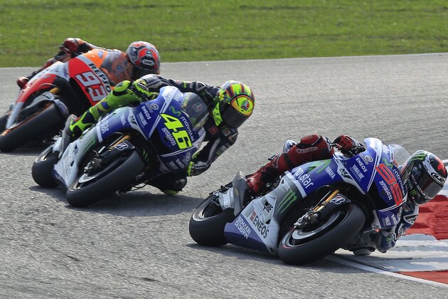 MotoGP rider Jorge Lorenzo, right, of Spain leads Valentino Rossi, center, of Italy, and Marc Marquez of Spain during the Malaysian Motorcycle Grand Prix in Sepang, Malaysia, Sunday, Oct. 26, 2014. (AP Photo/Lai Seng Sin)