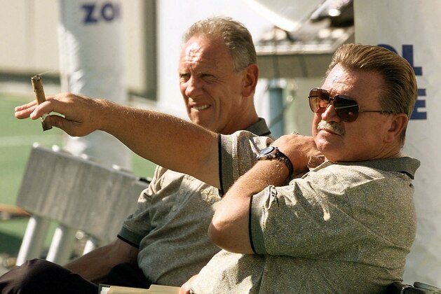 New Orleans Saints head coach Mike Ditka, front, holding his familiar cigar, relaxes on the sideline with offensive coordinator Danny Abramowicz before their pre-season game with the Tennessee Oilers in Memphis, Tenn. Saturday, Aug. 2, 1997. (AP Photo/Dave Martin)