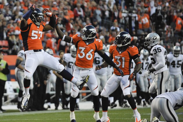 Denver Broncos linebacker Adrian Robinson (57) reacts with cornerback Kayvon Webster (36) and cornerback Omar Bolden (31) after a defensive play against the Oakland Raiders in the first quarter of an NFL football game, Monday, Sept. 23, 2013, in Denver. (AP Photo/Jack Dempsey)