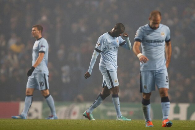 Manchester City's Yaya Toure, centre,  walks off the pitch after being given a red card, during the Champions League group E soccer match between Manchester City and CSKA Moscow, at the Etihad Stadium, in Manchester, England, Wednesday, Nov. 5, 2014. (AP Photo/Jon Super)