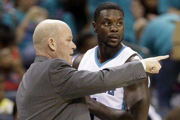 Charlotte Hornets head coach Steve Clifford, left, talks with Lance Stephenson, right, during the first half of a preseason NBA basketball game against the Detroit Pistons in Charlotte, N.C., Wednesday, Oct. 15, 2014. (AP Photo/Chuck Burton)