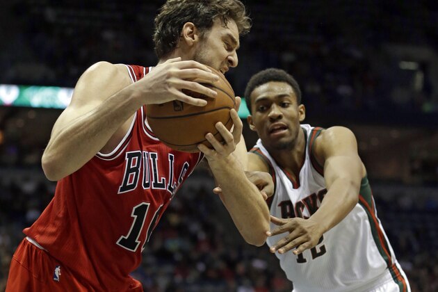 Chicago Bulls' Pau Gasol grabs a loose ball in front of Milwaukee Bucks' Jabari Parker during the second half of an NBA basketball game Wednesday, Nov. 5, 2014, in Milwaukee. (AP Photo/Morry Gash)
