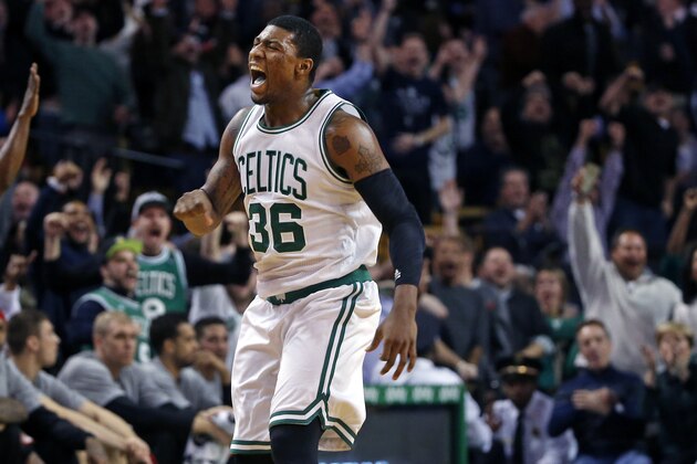 Boston Celtics guard Marcus Smart (36) celebrates with the fans after a made basket during the second half of an NBA basketball game against the Toronto Raptors in Boston, Wednesday, Nov. 5, 2014. (AP Photo/Elise Amendola)