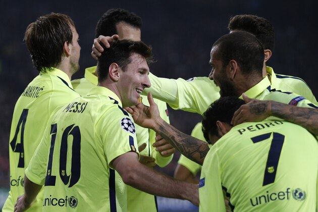 Barcelona's Lionel Messi celebrates with team mates scoring his side's 2nd goal during the Group F Champions League match between AFC Ajax and FC Barcelona at ArenA stadium in Amsterdam, Netherlands, Wednesday, Nov. 5, 2014. (AP Photo/Peter Dejong)