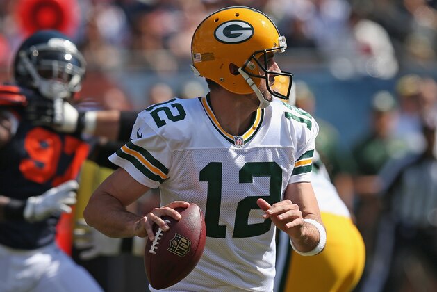 CHICAGO, IL - SEPTEMBER 28:  Aaron Rodgers #12 of the Green Bay Packers looks for a receiver against the Chicago Bears at Soldier Field on September 28, 2014 in Chicago, Illinois. The Packers defeated the Bears 38-17.  (Photo by Jonathan Daniel/Getty Images)