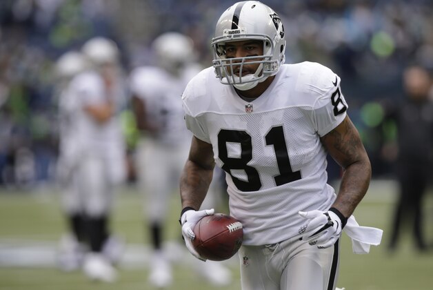 Oakland Raiders tight end Mychal Rivera runs with the ball during warmups before an NFL football game against the Seattle Seahawks, Sunday, Nov. 2, 2014, in Seattle. (AP Photo/Stephen Brashear)