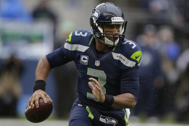 Seattle Seahawks quarterback Russell Wilson looks to pass against the Oakland Raiders in the first half of an NFL football game, Sunday, Nov. 2, 2014, in Seattle. (AP Photo/Stephen Brashear)