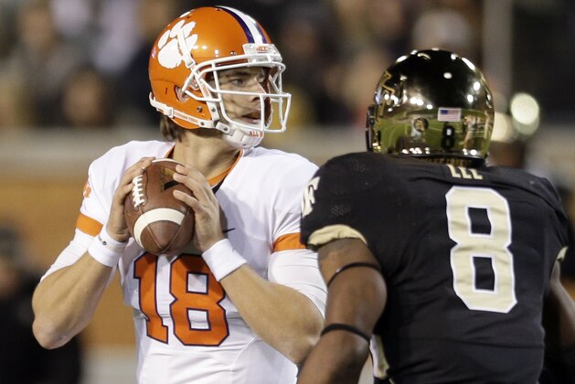 Clemson's Cole Stoudt (18) looks to pass as Wake Forest's Marquel Lee (8) closes in during the first half of an NCAA college football game in Winston-Salem, N.C., Thursday, Nov. 6, 2014. (AP Photo/Chuck Burton)