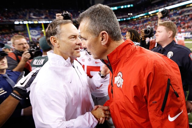 INDIANAPOLIS, IN - DECEMBER 07: Head coach Mark Dantonio of the Michigan State Spartans shakes hands with head coach Urban Meyer of the Ohio State Buckeyes after defeating the Buckeyes 34-24 to win the Big 10 Conference Championship Game at Lucas Oil Stadium on December 7, 2013 in Indianapolis, Indiana.  (Photo by Gregory Shamus/Getty Images)