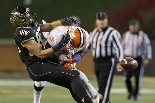 Wake Forest's Cam Serigne, left, is hit by Clemson's Robert Smith, right, during the second half of an NCAA college football game in Winston-Salem, N.C., Thursday, Nov. 6, 2014. Smith was ejected from the game. (AP Photo/Chuck Burton)