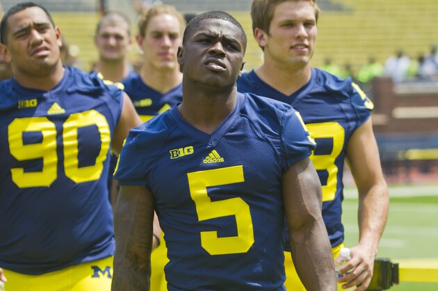 Michigan freshman cornerback Jabrill Peppers (5) walks with teammates to a team photo during the NCAA college football team's preseason media day, Sunday, Aug. 10, 2014, at Michigan Stadium in Ann Arbor, Mich. (AP Photo/Tony Ding)