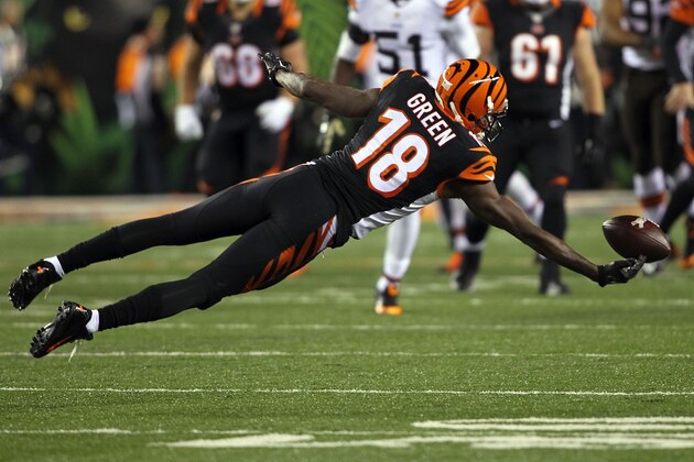 CINCINNATI, OH - NOVEMBER 6:  A.J. Green #18 of the Cincinnati Bengals dives in an attempt to catch a pass during the fourth quarter of the game against the Cleveland Browns at Paul Brown Stadium on November 6, 2014 in Cincinnati, Ohio. Cleveland defeated Cincinnati 24-3. (Photo by John Grieshop/Getty Images)