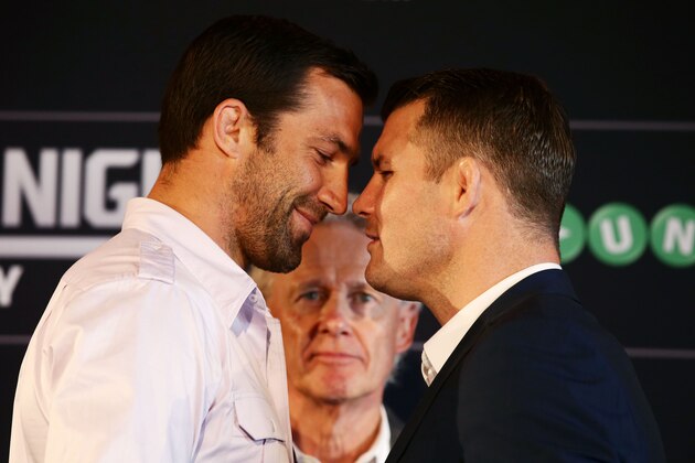 SYDNEY, AUSTRALIA - SEPTEMBER 11:  Luke Rockhold (L) and Michael Bisping (R) sqaure off as UFC Managing Director Australia, Canada and New Zealand Tom Wright (C) looks on during the UFC Fight Night: Rockhold v Bisping Press Event at Museum of Contemporary Art on September 11, 2014 in Sydney, Australia.  (Photo by Matt King/Getty Images)
