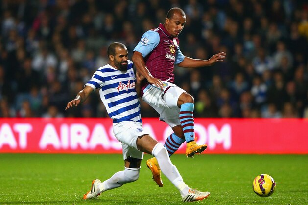 LONDON, ENGLAND - OCTOBER 27: Sandro of QPR tackles Gabriel Agbonlahor of Aston Villa  during the Barclays Premier League match between Queens Park Rangers and Aston Villa at Loftus Road on October 27, 2014 in London, England.  (Photo by Ian Walton/Getty Images)