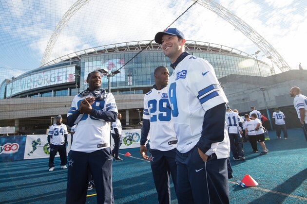 Dallas Cowboys quarterback Tony Romo, right, looks stands with running back DeMarco Murray, center, and wide receiver Dez Bryant, left, during a community day event outside Wembley Stadium in London, England, Tuesday Nov. 4, 2014. The Dallas Cowboys will play the Jacksonville Jaguars in an NFL football game at Wembley Stadium on Sunday Nov. 9 (AP Photo/Tim Ireland)