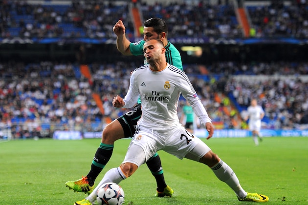 MADRID, SPAIN - MARCH 18:  Jese of Real Madrid goes down under a heavy tackle from Sead Kolasinac of Schalke during the UEFA Champions League Round of 16, second leg match between Real Madrid and FC Schalke 04 at Estadio Santiago Bernabeu on March 18, 2014 in Madrid, Spain.  (Photo by Denis Doyle/Getty Images)