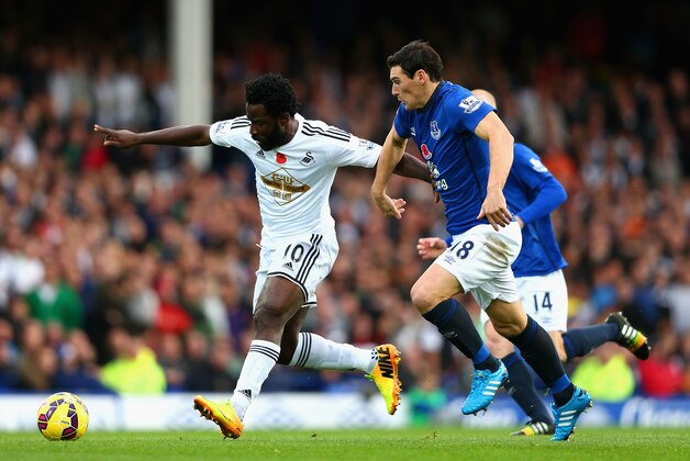 LIVERPOOL, ENGLAND - NOVEMBER 01:  Wilfried Bony of Swansea City is closed down by Gareth Barry of Everton during the Barclays Premier League match between Everton and Swansea City at Goodison Park on November 1, 2014 in Liverpool, England.  (Photo by Clive Brunskill/Getty Images)