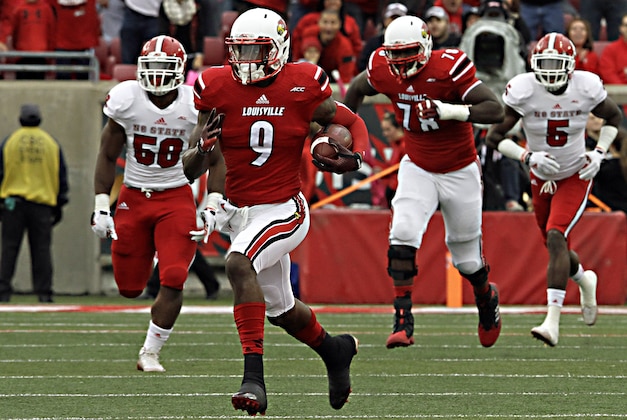 Louisville wide receiver DeVante Parker (9) gets loose in the North Carolina State secondary for a 37-yard completion in the NCAA college football game Saturday, Oct. 18, 2014 in Louisville, Ky. (AP Photo/Garry Jones)