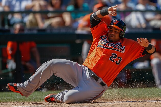 SEATTLE, WA - JULY 26:  Nelson Cruz #23 of the Baltimore Orioles scores on an error by third baseman Kyle Seager of the Seattle Mariners on a ball off the bat of Chris Davis in the eighth inning at Safeco Field on July 26, 2014 in Seattle, Washington. The Mariners defeated the Orioles 4-3.  (Photo by Otto Greule Jr/Getty Images)