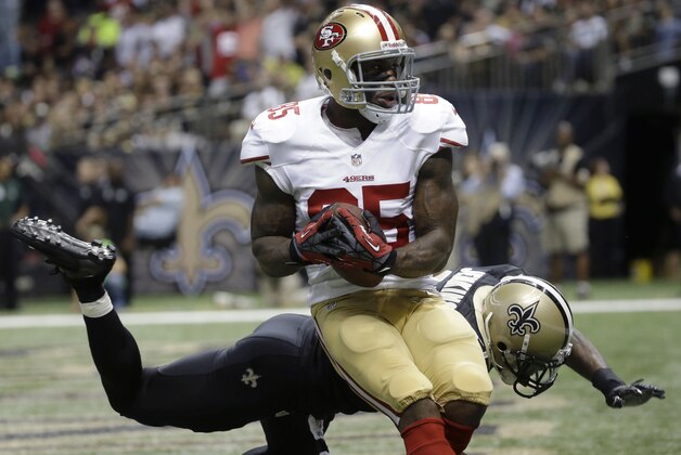San Francisco 49ers tight end Vernon Davis (85) pulls in a touchdown pass in front of New Orleans Saints free safety Malcolm Jenkins (27) in the second half of an NFL football game in New Orleans, Sunday, Nov. 17, 2013. (AP Photo/Dave Martin)