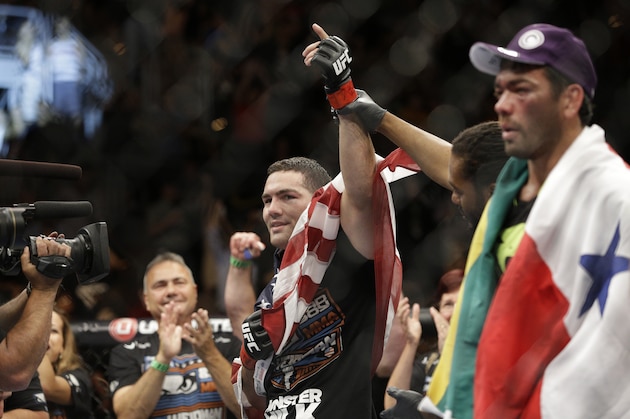 Chris Weidman celebrates after defeating Lyoto Machida, right, in their mixed martial arts middleweight title bout at UFC 175 Saturday, July 5, 2014, in Las Vegas. (AP Photo/John Locher)