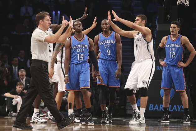 Oklahoma City Thunder guard Reggie Jackson (15) reacts alongside forward Serge Ibaka (9) and center Steven Adams (12) as Brooklyn Nets center Brook Lopez (11) celebrates with his teammates in the first half of an NBA basketball game, Monday, Nov. 3, 2014, in New York. The Nets won 116-85. (AP Photo/John Minchillo)