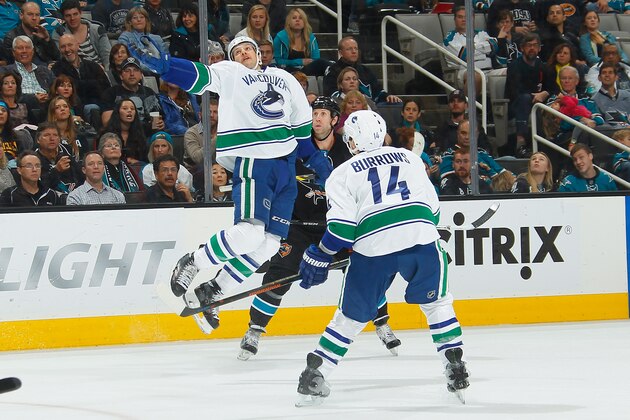 SAN JOSE, CA - NOVEMBER 6: Joe Thornton #19 of the San Jose Sharks skates after the puck against Alexandre Burrows #14 of the Vancouver Canucks during an NHL game on November 6, 2014 at SAP Center in San Jose, California. (Photo by Don Smith/NHLI via Getty Images)