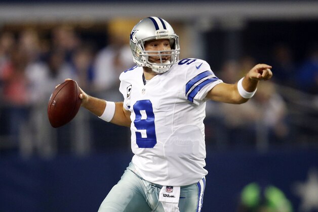 Dallas Cowboys quarterback Tony Romo directs his receivers as he scrambles out of the pocket during the first half of an NFL football game against the Washington Redskins, Monday, Oct. 27, 2014, in Arlington, Texas. (AP Photo/Tim Sharp)