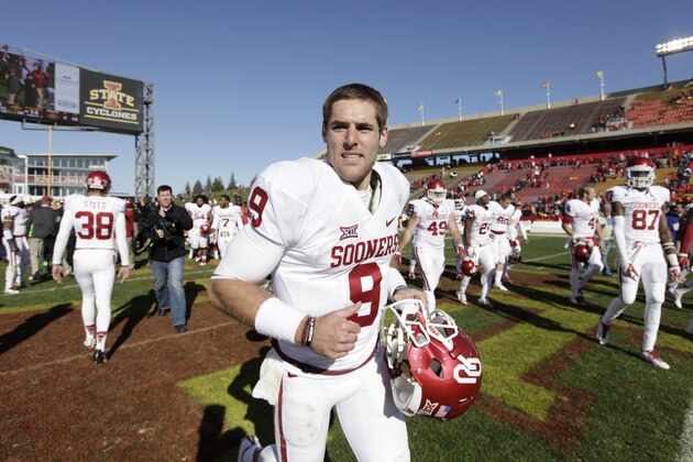 Oklahoma quarterback Trevor Knight runs off the field after an NCAA college football game against Iowa State, Saturday, Nov. 1, 2014, in Ames, Iowa. Oklahoma won 59-14. (AP Photo/Charlie Neibergall)